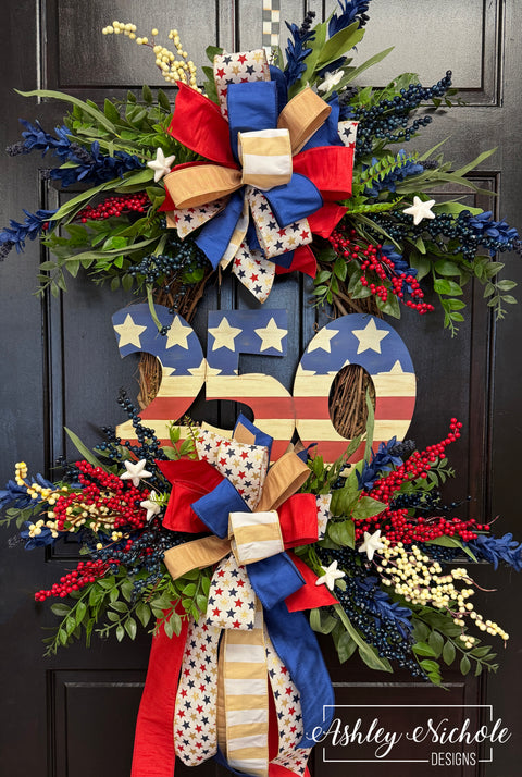 Decorative wreath with American flag design and colorful bow on a dark background