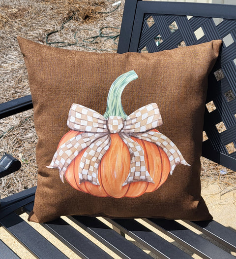 Our outdoor pumpkin pillow placed on a patio bench.